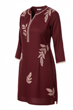 Angled view of embroidered rayon top